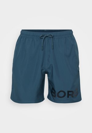 Teal men's swim shorts with an elastic waistband, drawstring, and a black "BORG" logo on the front. Smooth, lightweight fabric.