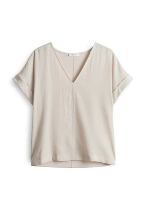 Short-sleeved, V-neck top in a light beige color. Made from a soft, textured fabric with a relaxed fit and subtle stitching detail.