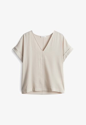 Top a maniche corte con scollo a V di un leggero colore beige. Realizzato in un morbido tessuto testurizzato, ha una vestibilità comoda e un sottile dettagli di cucitura.
