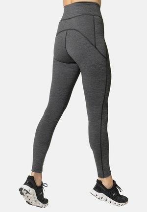 High-waisted gray athletic leggings with a textured finish, featuring contrasting stitching and a fitted design for full leg coverage.