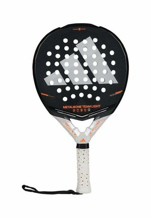Black padel racket with a perforated surface. Features an angled grip, white handle with dots, and subtle orange accents. Branding visible.