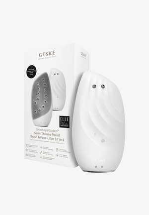 Vit sonic ansiktsborste med en slät, böjd design, texturerad silikonytan, två silverknappar och en produktlåda som visar detaljer.