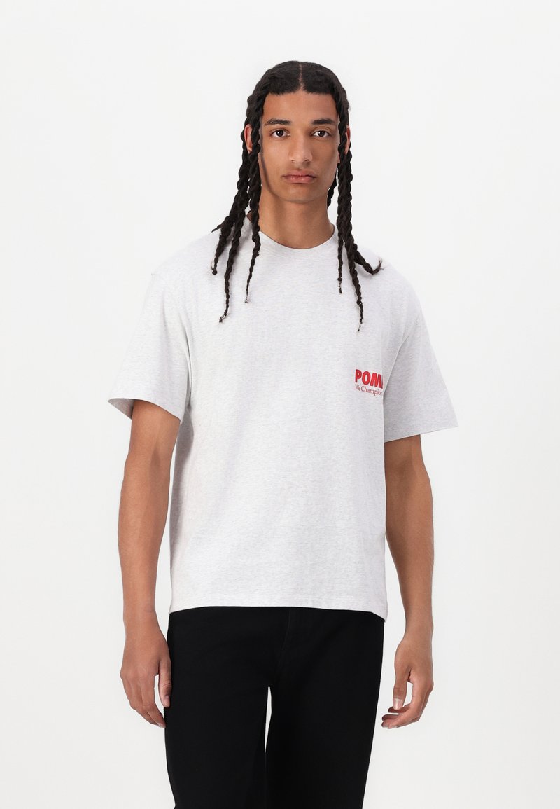 Gray cotton t-shirt with a crew neckline and short sleeves, featuring a red printed logo on the left chest. Textured fabric, relaxed fit.