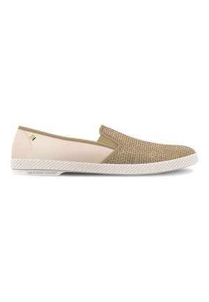 Des chaussures slip-on avec une tige en tissu texturé tan, un panneau beige et une semelle en caoutchouc blanc avec un bord texturé. Branding minimal sur le côté.