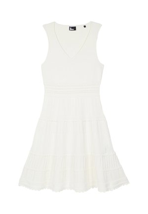 Biała sukienka bez rękawów z dekoltem w kształcie litery V, dopasowaną talią i warstwową spódnicą zdobioną delikatną koronką z oczkami na całej powierzchni.