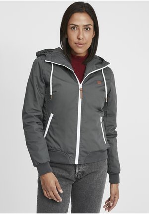 Gray hooded jacket with white zipper, drawstrings, and leather accent. Features elastic cuffs and zippered side pockets.