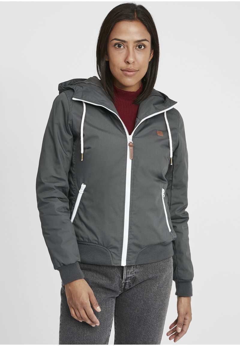 Gray hooded jacket with white zipper, drawstrings, and leather accent. Features elastic cuffs and zippered side pockets.