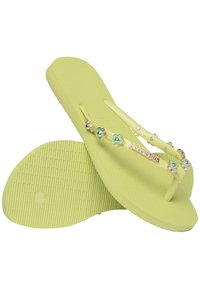 Yellow-green flip-flops with textured soles, embellished straps featuring floral accents, and a logo on the strap.
