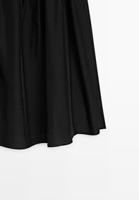 Black satin midi skirt with slight flare and smooth hem, hanging against a white background.