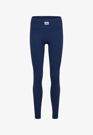 Marineblå leggings lavet af ribbet materiale, med en bred elastisk talje og et lille logomærke foran. Designet til at sidde tæt.