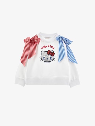 Bela jopa z motivom obraza Hello Kitty okrašenim s kristali, rdeče-modrimi črtastimi pentljami na ramenih in napisom "Hello Kitty" zgoraj.