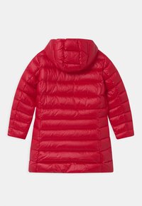 Rode pufferjas met een capuchon, voorzien van een gestikt ontwerp en horizontale padding. Glad, glanzend exterior met een middellange snit.