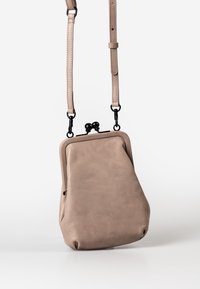 Borsa a tracolla in pelle beige con fondo arrotondato, chiusura metallica e tracolla regolabile. Texture liscia con design minimalista e senza motivi visibili.