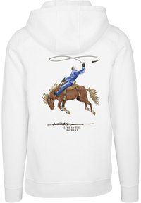 Weißer Hoodie mit einem Aquarelldruck eines Cowboys, der auf einem braunen Pferd reitet, mit einem Lasso in der Hand, und dem Text "LEBE IM MOMENT" darunter.