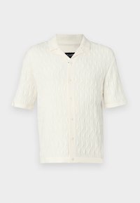 Gebreid shirt met korte mouwen in crèmekleur, met een golvende textuur, knoopsluiting en een spitse kraag. Gladde stof in effen kleur.