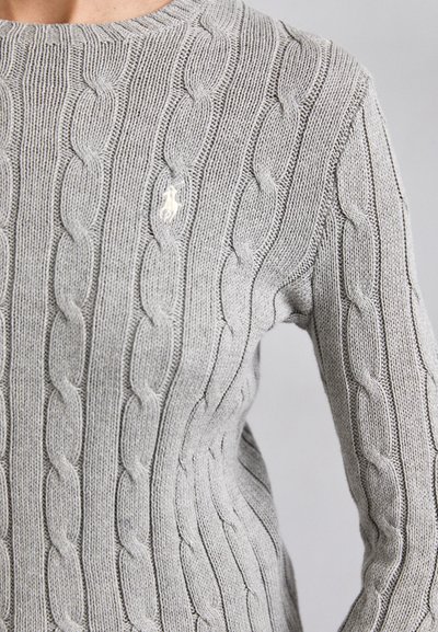 Gray cable knit sweater featuring a round neckline, textured pattern, and a small embroidered logo on the chest. Cozy, knit fabric.