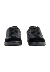 Black athletic shoes featuring a combination of leather and suede materials, round laces, and textured soles, with a low-profile design.