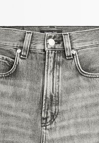 Gray denim jeans with a high waist, featuring a classic five-pocket design, metal button closure, and contrasting stitching.