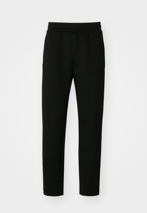 Mustad jogger püksid, mis on valmistatud pehmest ja elastsest kangast. Omavad keha lähedast vormi, elastset vööd ja küljetaskut. Lihtne, minimalistlik disain.