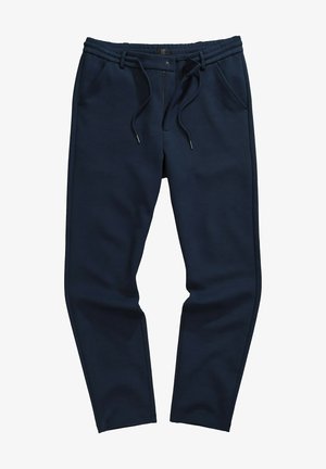 Jogging bleu marine avec taille à cordon, poches latérales, jambes fuselées et un tissu doux et texturé. Couture d'accent visible.