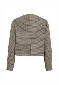 Krátká bunda s dlouhými rukávy s černo-bílo-červeným vzorem psa zobrazená zezadu.