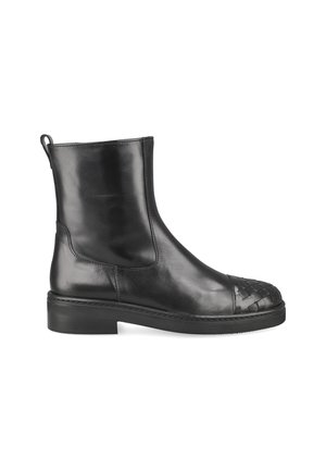 Black leather ankle boot with woven leather toe cap and flat rubber sole, side view on white background.