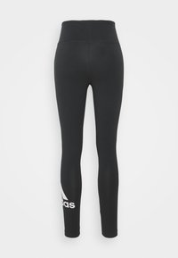 Černé legíny s vysokým pasem, vyrobené z hladkého elastického materiálu. Na dolní levé noze mají bílé logo adidas.