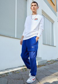 Nike Sportswear AIR WINTER PANT - Cargo trousers - deep royal blue/white