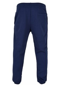 Pantalones jogger azul marino hechos de una tela suave. Cuentan con una cinturilla elástica y dobladillos ajustados, con dos bolsillos laterales y un bolsillo trasero.