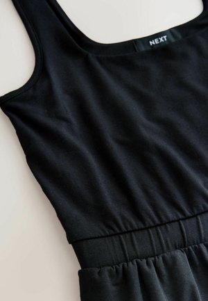 Black sleeveless dress with gathered waist and square neckline, branded "NEXT" on inside label.