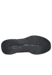 Suola di scarpa atletica nera con gomma testurizzata e scanalature profonde per la trazione. Etichetta "Vapor Foam" visibile sul lato.