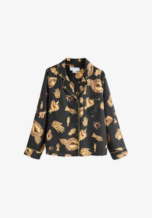 Saténový pyžamový top s motivy zlatých rukou a srdcí na černém pozadí, se žlutým obrysem a náprsní kapsou. Dlouhé rukávy.