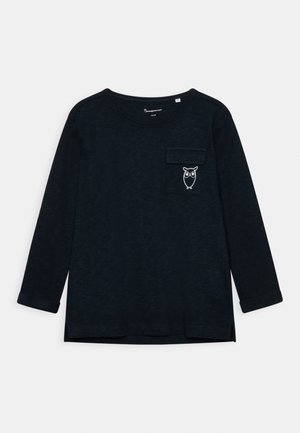 Black long-sleeve shirt with a round neck and a small pocket on the left chest featuring a white owl graphic.