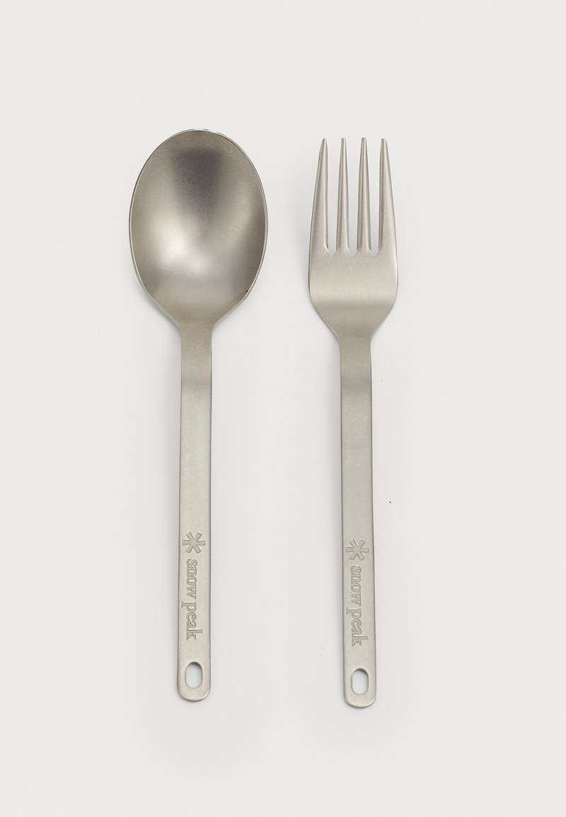 Stainless steel spoon and fork set, featuring smooth surfaces, matte finish, elongated handles, and engraved brand name.