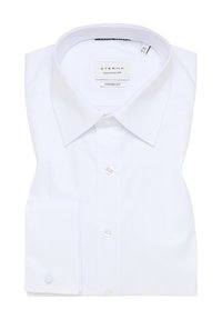 Valkoinen pitkähihainen paita, jossa on klassinen kaulus, ETERNA:n merkki, mukava istuvuus, napillinen etulista ja yksittäinen hihansuu napilla.