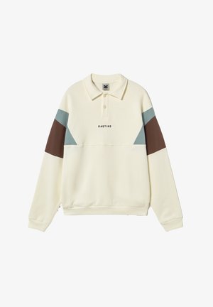 Langärmliges Poloshirt in Cremeton mit blauen und braunen Farbfeldern an den Ärmeln und dem Schriftzug "KAOTIKO" mittig vorne.