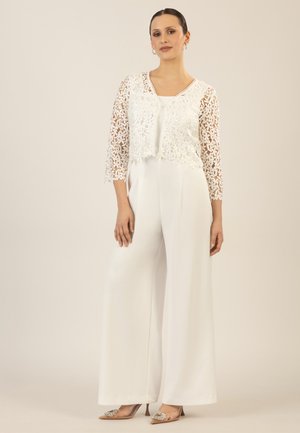 White jumpsuit with wide legs and a fitted bodice, layered with a semi-sheer, floral lace overlay featuring three-quarter sleeves.