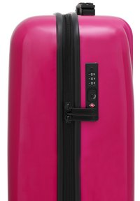 Hard-shell pink suitcase with a glossy finish, black zipper, combination lock, and a sturdy handle on top for carry.