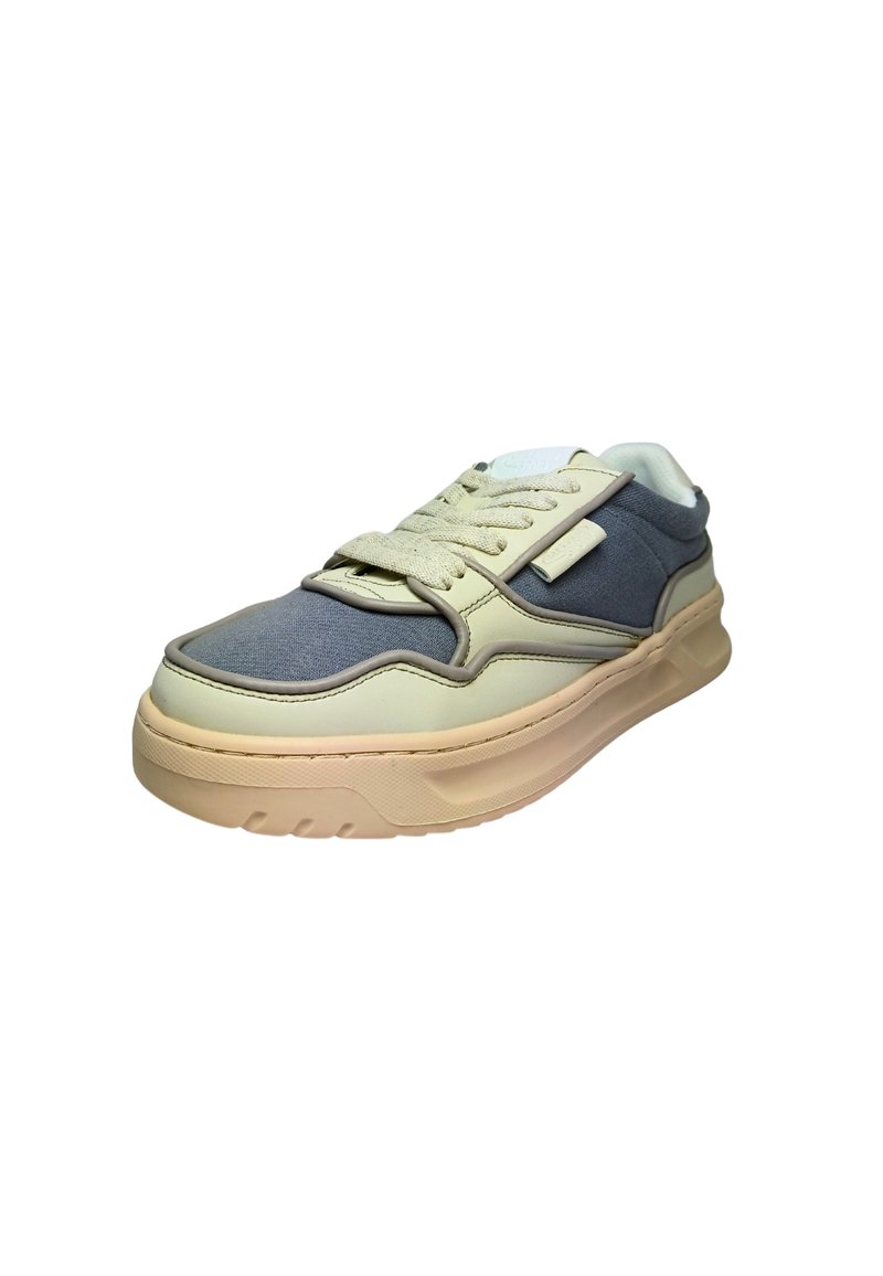 Multi-material sneaker with a beige and gray upper, textured fabric and smooth leather, round toe, thick rubber sole, and lace-up closure.
