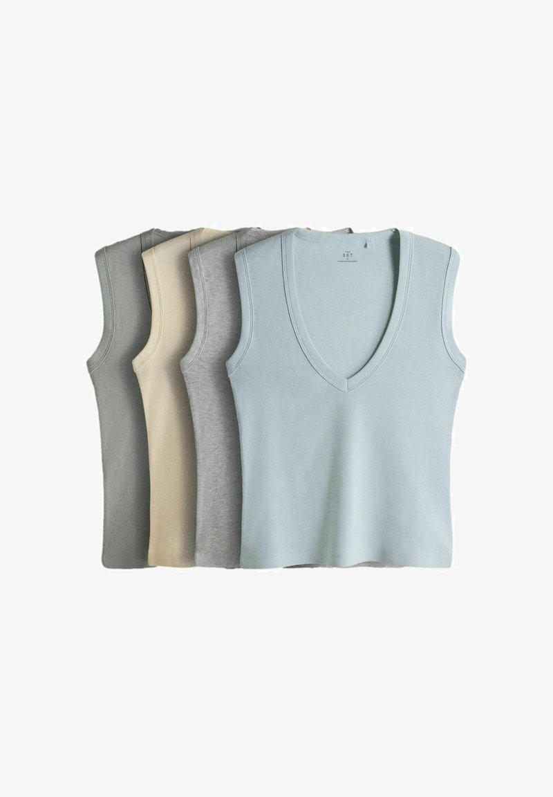 Conjunto de cinco tops sin mangas de punto con escote en V en colores pastel y neutros, apilados ordenadamente uno al lado del otro.