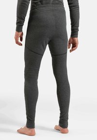 Graue thermische Leggings aus weichem, elastischem Material mit enganliegender Passform, ausgestattet mit einem glatten Bund und subtilen Nahtdetails.