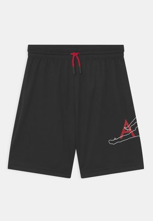Czarne sportowe spodenki z elastycznym pasem i czerwonym sznurkiem, z białym i czerwonym motywem leżącej postaci na prawej nodze.
