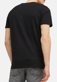Black short-sleeve t-shirt with a crew neck, made of soft fabric. Features a simple design with no patterns or visible logos.
