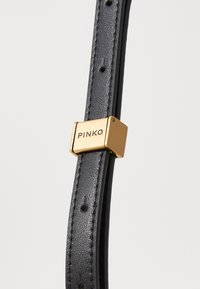 Black leather strap with a textured finish, featuring a gold square clasp embossed with the brand name "PINKO."