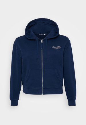 Navy blauwe zip-up hoodie gemaakt van een katoenmix, met een voorzak en ribgebreide manchetten. Voorzien van een witte geborduurde logo op de borst.