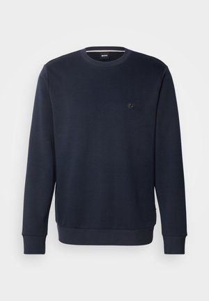 Sweatshirt bleu marine à col rond, en tissu doux, avec un petit logo en relief sur la poitrine et des poignets et un ourlet côtelés.