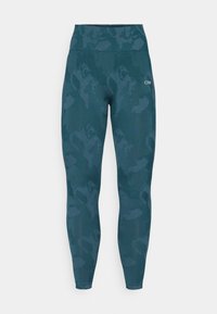 Hooggeribbelde leggings in een donkere teal kleur met een subtiel camouflagemotief, gemaakt van rekbare stof met een zachte textuur.
