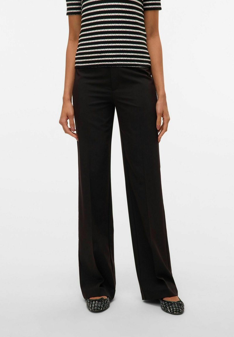 Black wide-leg pants made from smooth fabric, featuring a tailored design with a crisp finish. Paired with a striped short-sleeve top.