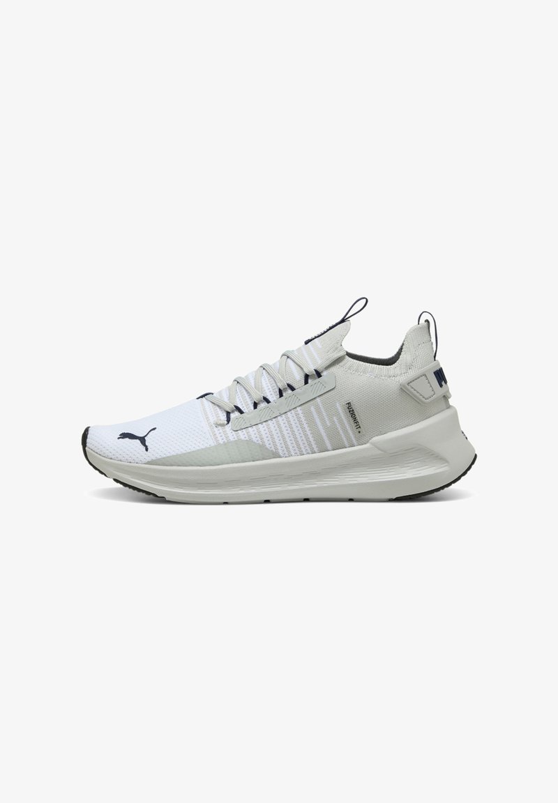 White athletic sneakers with a textured mesh upper, gray accents, and a cushioned sole. Features laces and a logo on the side.