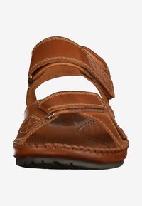 Brown leather sandals with two adjustable straps, open toe design, textured insole, and stitched edges. Solid rubber sole for grip.